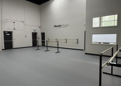 The dance practice hall at Trilogy Dance Academy, featuring spacious floors, and a vibrant atmosphere for rehearsals and training.