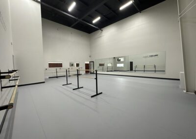 The dance practice hall at Trilogy Dance Academy, featuring spacious floors, mirrors, and a vibrant atmosphere for rehearsals and training.